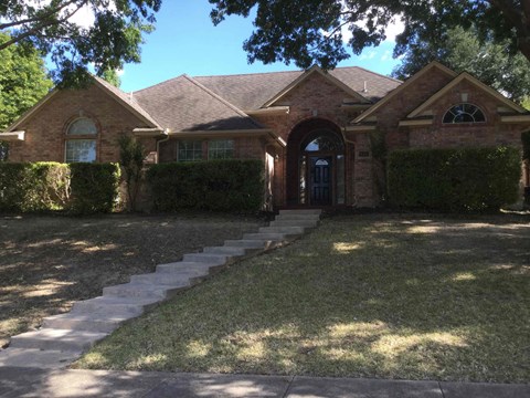 front of the house with steps leading up to the front door